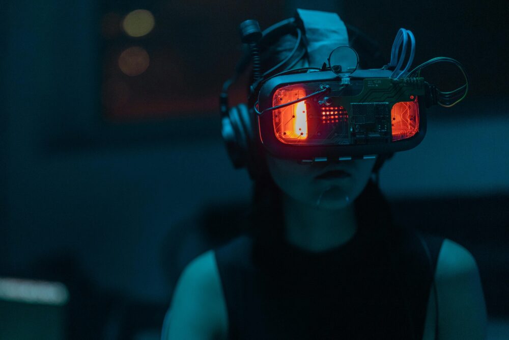Person wearing futuristic VR headset with glowing red lights.