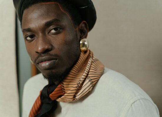 Close-up of a person wearing a black beret and a patterned scarf.