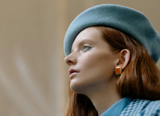 A person wearing a blue beret and a blue checkered shirt.