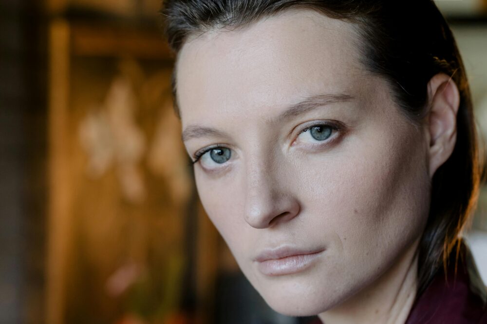 Close-up portrait of a person with striking blue eyes.