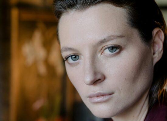 Close-up portrait of a person with striking blue eyes.
