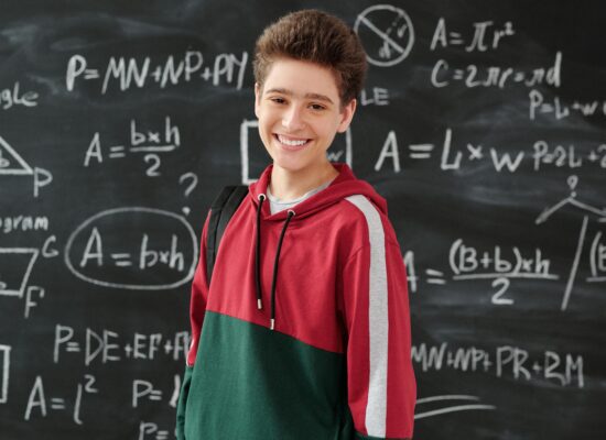 Person preparing tea with various dried herbs and flowers.
