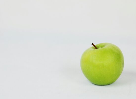 A single green apple on a plain white background.