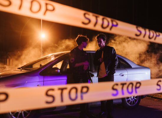 Person with hands on temples, eyes closed, appearing stressed or thoughtful.