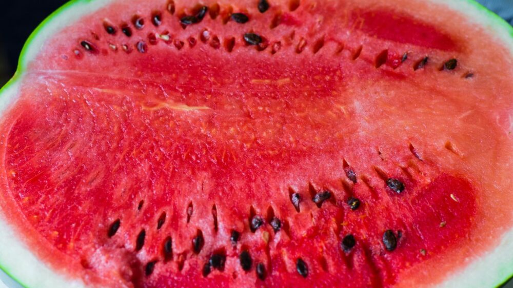 Close-up of a sliced watermelon showing seeds and red flesh.