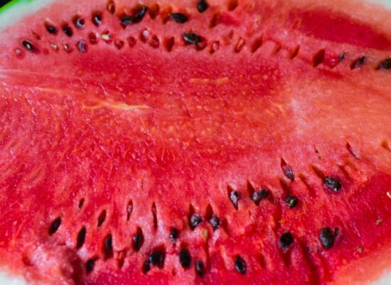 Close-up of a sliced watermelon showing seeds and red flesh.